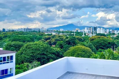 a view of a city from the balcony of a house at Torre Solarium next to PUCMM in Santiago de los Caballeros