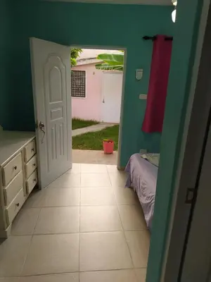 a room with a door leading to a bedroom at Central Rooms Bayahibe in Bayahibe