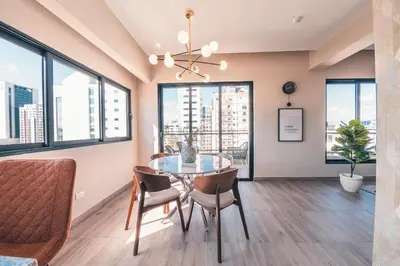a dining room with a table and chairs and windows at Breakfast Included at Regatta Living 802 in Los Prados