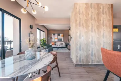 a dining room with a table and chairs at Breakfast Included at Regatta Living 802 in Los Prados