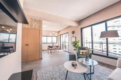 a living room with a table and chairs at Breakfast Included at Regatta Living 802 in Los Prados