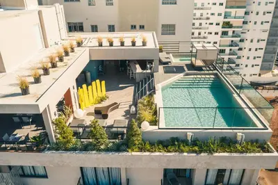 an aerial view of a building with a swimming pool at Breakfast Included at Regatta Living 802 in Los Prados