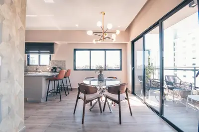 a dining room with a table and chairs at Breakfast Included at Regatta Living 802 in Los Prados
