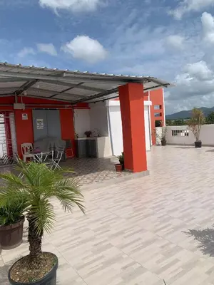 a pavilion with a palm tree on a patio at Plataview Apartahotel apt 4C in Monte Plata