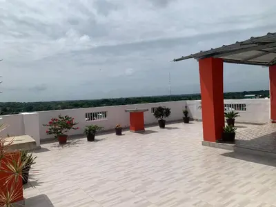a patio with potted plants on top of a building at Plataview Apartahotel apt 4C in Monte Plata