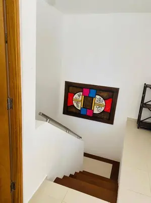 a staircase with a stained glass window on the wall at Heavenly View in San Felipe de Puerto Plata
