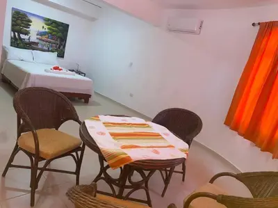 a bedroom with a table and chairs and a bed at Heavenly View in San Felipe de Puerto Plata