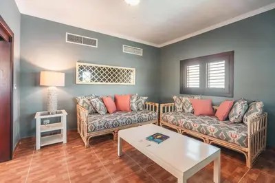 a living room with two couches and a table at Seaside Bliss with pool and spectacular view in Las Minas