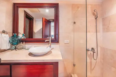 a bathroom with a sink and a glass shower at Seaside Bliss with pool and spectacular view in Las Minas