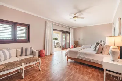 a bedroom with a bed and a couch at Seaside Bliss with pool and spectacular view in Las Minas