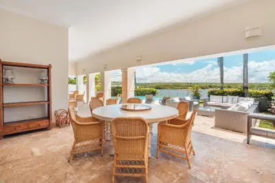a dining room with a table and chairs at Seaside Bliss with pool and spectacular view in Las Minas