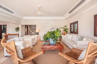 a living room with white furniture and a table at Seaside Bliss with pool and spectacular view in Las Minas