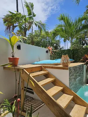 a patio with a bed and a swimming pool at Casa Shambala B&B in Las Terrenas