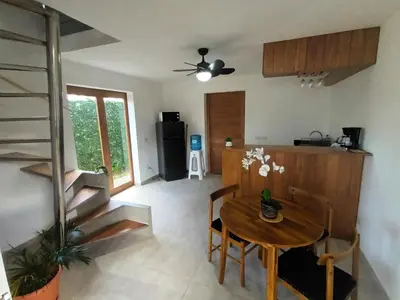 a kitchen and dining room with a wooden table at Casa Shambala B&B in Las Terrenas