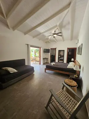 a living room with two beds and a couch at Casa Shambala B&B in Las Terrenas