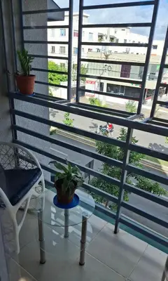 a balcony with a chair and a table and windows at Apartamento acogedor J-A in Los Paredones