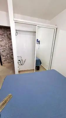 a room with a bed and a sliding door at Apartamento acogedor J-A in Los Paredones