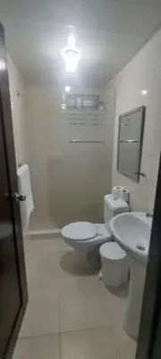 a white bathroom with a toilet and a sink at Apartamento acogedor J-A in Los Paredones