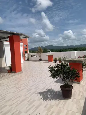 a large courtyard with a building at Plataview Apartahotel apt 3C in Monte Plata
