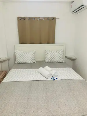 a bed with two towels and two pillows on it at Plataview Apartahotel apt 3C in Monte Plata