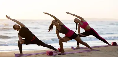 a group of people doing yoga on the beach at Royalton CHIC Punta Cana, An Autograph Collection All-Inclusive Resort & Casino, Adults Only in Punta Cana