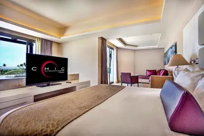 a hotel room with a bed and a flat screen tv at Royalton CHIC Punta Cana, An Autograph Collection All-Inclusive Resort & Casino, Adults Only in Punta Cana