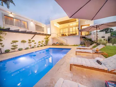 a swimming pool in the backyard of a house at Luxurious Listed New Villa With 5 Br- 6 Bt In Sosua in Sosúa