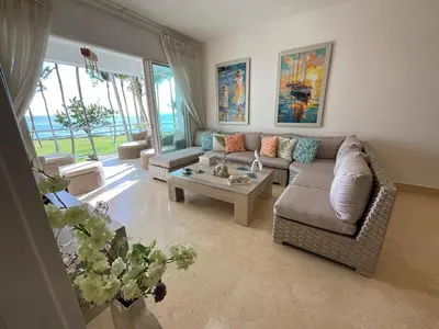 a living room with a couch and a table at SEAWINDS CABARETE Front beach Condo in Cabarete