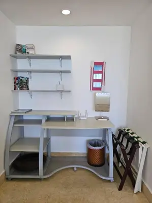 an office with a desk with a lamp and a chair at SEAWINDS CABARETE Front beach Condo in Cabarete