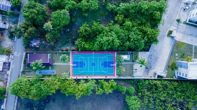 an overhead view of a swimming pool with trees at Breezes by TECASA in Santiago de los Caballeros