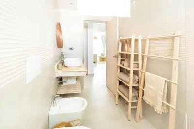 a bathroom with a white toilet and a sink at Estrella Dominicus Ekskluzywny Apartament ,,Bajeczny Widok,, in La Laguna