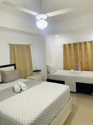 a bedroom with two beds and a ceiling at Plataview Apartahotel apt 4A in Monte Plata