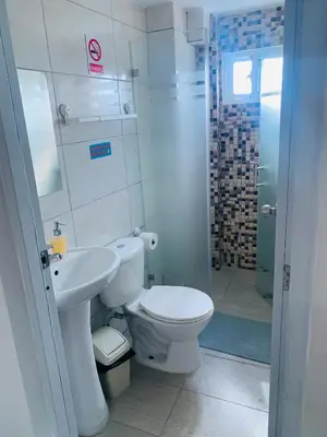 a bathroom with a toilet and a sink and a shower at Plataview Apartahotel apt 4A in Monte Plata
