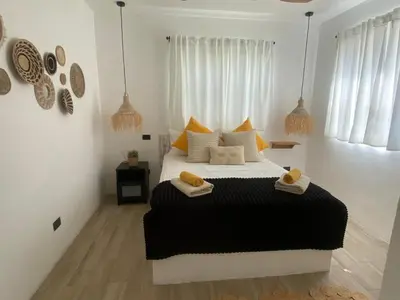 a bedroom with a large bed with towels on it at Portitxol, fantástico apartamento in Bayahibe