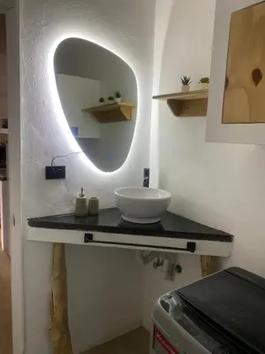 a bathroom with a sink and a mirror on a counter at Portitxol, fantástico apartamento in Bayahibe