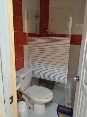 a bathroom with a toilet and a sink at Petite Lounge in Los Paredones