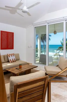 a living room with a view of the beach at Las Canas Beach Retreat in Gaspar Hernández