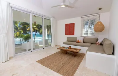 a living room with a couch and a table at Las Canas Beach Retreat in Gaspar Hernández