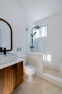 a bathroom with a toilet and a sink and a mirror at Las Canas Beach Retreat in Gaspar Hernández