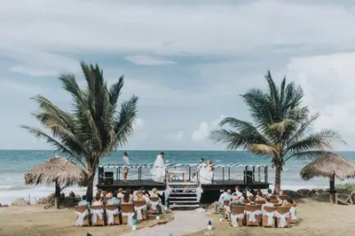 a wedding on the beach with a group of people at Surf and Yoga Retreat for Groups Near Cab! in Gaspar Hernández