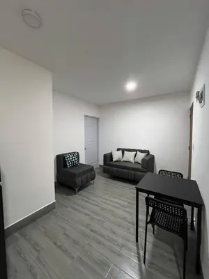 a living room with a table and a couch at La Yarolina in Punta Cana