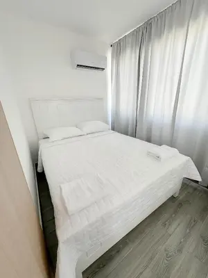 a bedroom with a bed with white sheets and a window at La Yarolina in Punta Cana