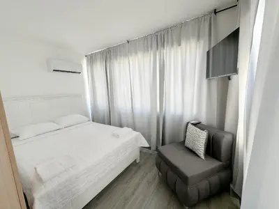a small bedroom with a bed and a chair at La Yarolina in Punta Cana