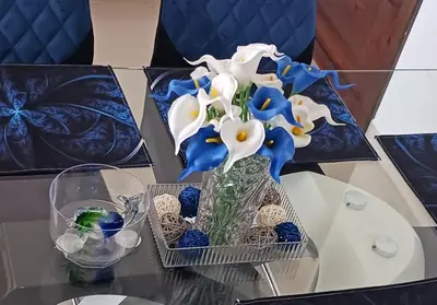 a vase of blue and white flowers on a table at Chelsie 402 in Bayahibe