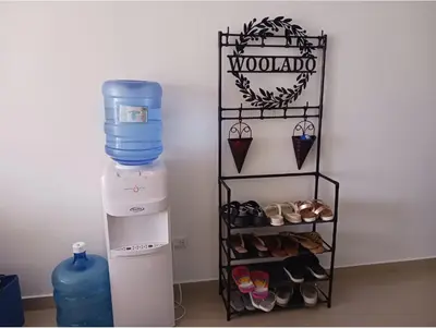 a shelf with shoes and a water bottle in a room at Chelsie 402 in Bayahibe