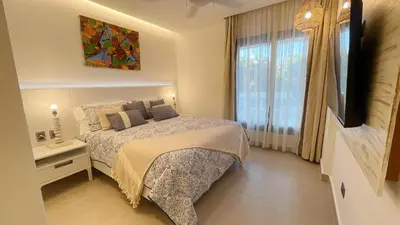 a bedroom with a bed and a large window at Tropical Relaxing 2 Bedroom Unit with picuzzi in Punta Cana