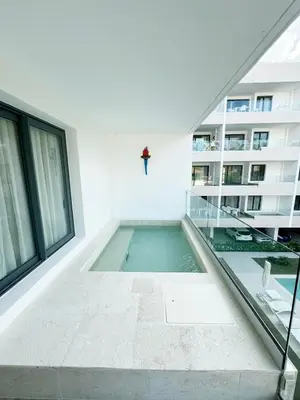 a swimming pool in the middle of a building at Tropical Relaxing 2 Bedroom Unit with picuzzi in Punta Cana