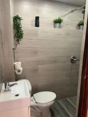 a small bathroom with a toilet and a sink at Island Life Hostel in Santo Domingo