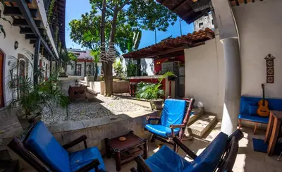 a group of chairs sitting on a patio at Island Life Hostel in Santo Domingo