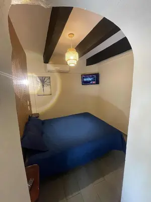 a bedroom with a blue bed in a room at Island Life Hostel in Santo Domingo